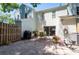 Spacious brick patio with outdoor seating, a grill, and mature landscaping, ideal for entertaining at 1728 Mill Run Cir, Tampa, FL 33613