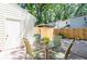 Private brick-paved patio with outdoor seating and a white storage shed, surrounded by trees and a fence at 1728 Mill Run Cir, Tampa, FL 33613