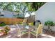 Brick-paved patio area with outdoor seating surrounded by a wooden fence and lush greenery at 1728 Mill Run Cir, Tampa, FL 33613