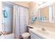 Bathroom featuring tub with floral shower curtain, white cabinets and modern faucet at 1728 Mill Run Cir, Tampa, FL 33613