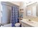 Hall bathroom featuring a blue patterned shower curtain, a mirror and vanity area at 1728 Mill Run Cir, Tampa, FL 33613
