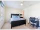 Comfortable bedroom with lots of natural light, dark bed frame and functional workstation at 1728 Mill Run Cir, Tampa, FL 33613