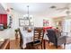Open-concept dining area with hardwood floors, stylish lighting, and open to the living space at 1728 Mill Run Cir, Tampa, FL 33613