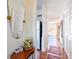 Inviting hallway featuring hardwood floors, a decorative table, and a view of the backyard at 1728 Mill Run Cir, Tampa, FL 33613