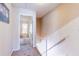 Upstairs hallway with neutral walls and carpet, leading to bedrooms with natural light at 1728 Mill Run Cir, Tampa, FL 33613