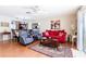 Spacious living area open to dining with a bright sofa and access to the outdoor patio at 1728 Mill Run Cir, Tampa, FL 33613