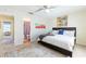 Relaxing main bedroom leads into the bathroom featuring a neutral color palette, large windows, and a cozy rug at 1728 Mill Run Cir, Tampa, FL 33613