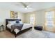 Relaxing main bedroom featuring a neutral color palette, large windows, and a cozy rug at 1728 Mill Run Cir, Tampa, FL 33613