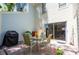 Outdoor patio with table, chairs, grill, brick pavers, and sliding glass doors into the house at 1728 Mill Run Cir, Tampa, FL 33613