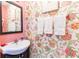 Stylish powder room with floral wallpaper, a sleek vanity, and attractive decor at 1728 Mill Run Cir, Tampa, FL 33613
