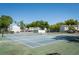 View of a community tennis court with a green and blue surface and mature trees in the background at 1728 Mill Run Cir, Tampa, FL 33613