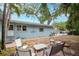 Backyard features tropical landscaping, a blue home and a patio set at 1736 23Rd N Ave, St Petersburg, FL 33710