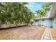 Backyard features tropical landscaping, a blue home and a patio set at 1736 23Rd N Ave, St Petersburg, FL 33710