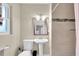 Bathroom featuring tiled walls, updated fixtures, and a shower with glass door at 1736 23Rd N Ave, St Petersburg, FL 33710