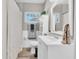 Bright bathroom featuring white wainscoting, vanity with white countertop, and a shower/tub combo at 1736 23Rd N Ave, St Petersburg, FL 33710