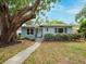 Charming single-story home with mature trees and a well-manicured lawn at 1736 23Rd N Ave, St Petersburg, FL 33710