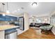 Open-concept kitchen and living area with stainless steel appliances and stylish blue cabinets at 1736 23Rd N Ave, St Petersburg, FL 33710