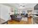 Cozy living room with hardwood floors, large sectional couch, and abundant natural light at 1736 23Rd N Ave, St Petersburg, FL 33710