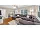 Spacious living room with a large sectional couch, hardwood floors, and bright windows at 1736 23Rd N Ave, St Petersburg, FL 33710