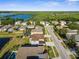 Scenic aerial view of a residential area with a pond and tree-lined streets at 17917 Machair Ln, Land O Lakes, FL 34638