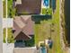 Backyard aerial view showing a green yard with a patio area, pool, and lake access at 17917 Machair Ln, Land O Lakes, FL 34638