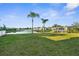 Expansive backyard featuring a tranquil lake view and lush green lawn at 17917 Machair Ln, Land O Lakes, FL 34638