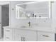 Bright bathroom featuring a marble countertop, gold faucet, and illuminated mirror at 17917 Machair Ln, Land O Lakes, FL 34638
