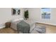Cozy bedroom with a bed, rug, and window view of the lake at 17917 Machair Ln, Land O Lakes, FL 34638