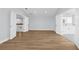 Expansive bedroom with modern wood floors, bright natural light, and entryways to other rooms at 17917 Machair Ln, Land O Lakes, FL 34638