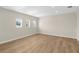Spacious bedroom featuring hardwood floors and three windows offering plenty of natural light at 17917 Machair Ln, Land O Lakes, FL 34638
