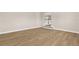 Large bonus room with hardwood floors and an open view of the stairs and landing area at 17917 Machair Ln, Land O Lakes, FL 34638