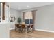 Dining area showcases a wooden table with seating and soft natural light from the window at 17917 Machair Ln, Land O Lakes, FL 34638