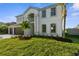 Two-story home with a well-manicured lawn and lush landscaping at 17917 Machair Ln, Land O Lakes, FL 34638