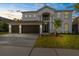 Charming two-story home with a well-manicured lawn and a spacious three-car garage at 17917 Machair Ln, Land O Lakes, FL 34638