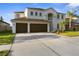 Charming two-story home with a well-manicured lawn and a spacious three-car garage at 17917 Machair Ln, Land O Lakes, FL 34638