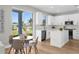 Eat-in kitchen featuring white cabinets, an island, stainless appliances, and backyard views at 17917 Machair Ln, Land O Lakes, FL 34638