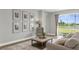 Inviting living room with a plush sofa, accent chair, and scenic water view at 17917 Machair Ln, Land O Lakes, FL 34638