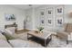 Cozy living room featuring a plush rug, comfortable seating, and stylish decor at 17917 Machair Ln, Land O Lakes, FL 34638