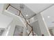 Grand staircase with white railings and wooden trim, complemented by a stylish pendant light at 17917 Machair Ln, Land O Lakes, FL 34638