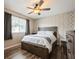 Comfortable bedroom with stylish wallpaper, ceiling fan, wood floors, and a bed with under-bed storage at 1821 Bough Ave # 4, Clearwater, FL 33760