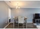 Neutral dining room featuring modern table and chairs plus wood-look flooring, and contemporary chandelier at 1821 Bough Ave # 4, Clearwater, FL 33760