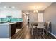 Dining area featuring a modern table set, chandelier lighting, and beautiful wood-look flooring at 1821 Bough Ave # 4, Clearwater, FL 33760