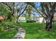 Lush lawns, mature trees, and a tennis court add to the community's curb appeal and recreational opportunities at 1821 Bough Ave # 4, Clearwater, FL 33760