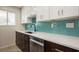 Beautiful kitchen with stainless steel appliances, white counters, and stylish blue backsplash at 1821 Bough Ave # 4, Clearwater, FL 33760