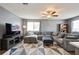 Inviting living room featuring a plush sectional sofa, ceiling fan, and decorative rug at 1821 Bough Ave # 4, Clearwater, FL 33760