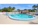 Community pool with clear blue water, lounge chairs, and palm trees creating a relaxing outdoor space at 1821 Bough Ave # 4, Clearwater, FL 33760