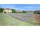 An outdoor tennis court with green surface provides recreational opportunities at this home's community at 1821 Bough Ave # 4, Clearwater, FL 33760