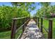 A wooden bridge invites you to explore the community's natural beauty, surrounded by verdant landscaping at 1821 Bough Ave # 4, Clearwater, FL 33760