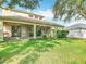 Lush backyard with a screened-in porch, well-kept lawn, and exterior view of the house at 2256 Pantucket Dr, Wesley Chapel, FL 33543