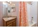 Bathroom featuring sink with wood cabinets, mirror, and shower with polka dot curtain at 2256 Pantucket Dr, Wesley Chapel, FL 33543